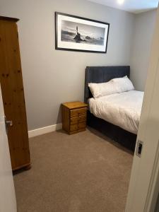 a small bedroom with a bed and a night stand at Fado apartment 2 in Bantry +4 photos