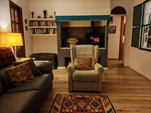 a living room with a couch and a chair and a fireplace at Casa Rural Los Estrello in Puntallana