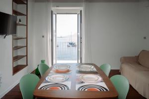 a table with plates on it in a living room at Radici 1937 - Lodge sul mare in Scilla