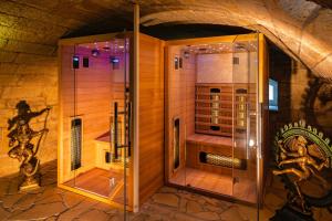 a walk in shower in a room in a building at Rathener Hof by STEIGER Hotels in Kurort Rathen