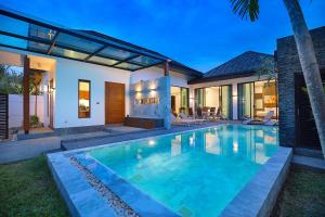 a swimming pool in the backyard of a house at 3 BR coco Pool Villa Kamala Beach in Kamala Beach