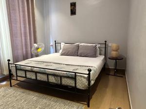 a bedroom with a bed with a black frame at Cozy corner in Kigali