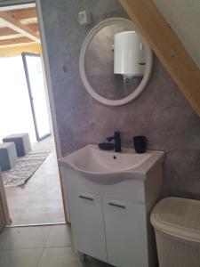 a bathroom with a sink and a mirror on the wall at Pax Montana in Blidinje