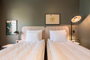two beds sitting next to each other in a room at Scandic Helsinki Station in Helsinki