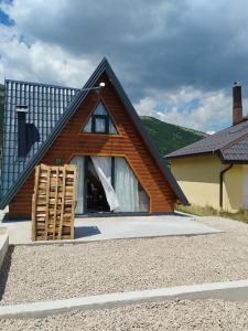 a wooden house with a gambrel roof at Pax Montana in Blidinje +24 photos