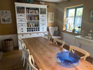 a dining room with a wooden table and chairs at Ferienhaus an der Ostsee mit großem Garten in Rerik +25 photos