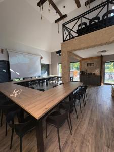 a conference room with a large wooden table and chairs at Guciowy Zakątek & SPA sauna, jacuzzi, tężnia in Zwierzyniec