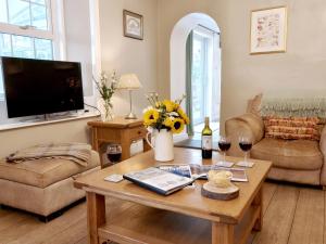 a living room with a table and two glasses of wine at Bush Nook House in Brampton