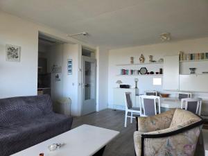 a living room with a couch and a table at Appartementencomplex Juliana 162 in De Koog