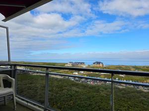 a balcony with a view of the ocean at Appartementencomplex Juliana 162 in De Koog