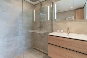 a bathroom with a shower and a sink at Appartementencomplex Juliana 162 in De Koog