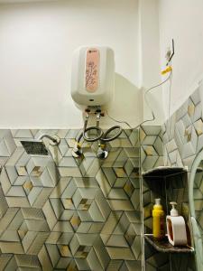 a bathroom with a soap dispenser on the floor at The Boho House in Darbhanga