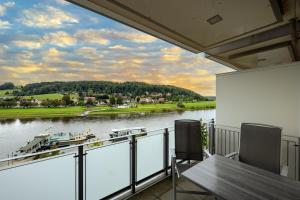 a balcony with a view of a river at Rathener Hof by STEIGER Hotels in Kurort Rathen