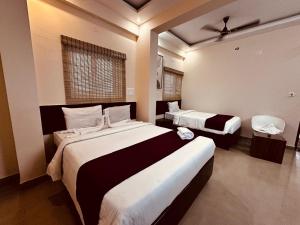 a hotel room with two beds and a window at Urban Stay in Bengaluru +19 photos