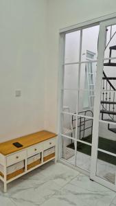a room with a desk and a chair next to a window at adinda syariah H-1 Villa Anggrek Jl Proklamasi in Garut
