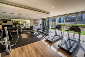 a gym with treadmills and cardio equipment in a building at 2BhK Big Balcony&Canal View Waterfront dubai mall in Dubai