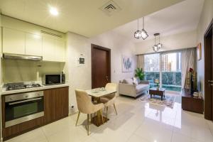 a kitchen and living room with a couch and a table at 2BhK Big Balcony&Canal View Waterfront dubai mall in Dubai