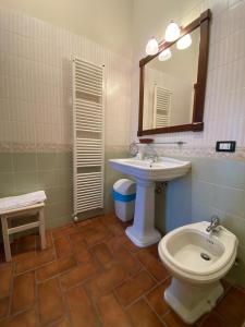 a bathroom with a sink and a toilet and a mirror at Agriturismo La Bisa in Trecenta