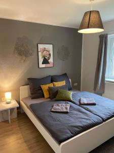 a bedroom with a bed with a blue comforter at Ferienhaus "Hagen" in Schkopau in Schkopau