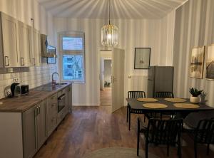 a kitchen and dining room with a table and chairs at Appartement "Hans" in Köthen mit 4 Schlafzimmern in Köthen