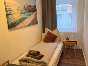 a small bedroom with a bed with a towel on it at Appartement "Hans" in Köthen mit 4 Schlafzimmern in Köthen