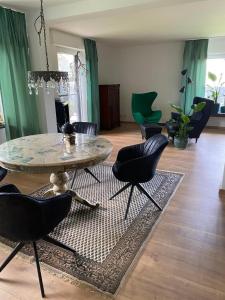 a living room with a table and chairs at Haus Sengbach in Heide