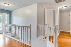 a white staircase in a home with white walls at Modern 1- Queen Bed On Quiet Block in Augusta