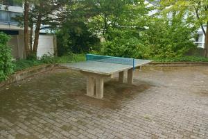 a ping pong table sitting on a brick patio at Eastside Karlsruhe in Karlsruhe
