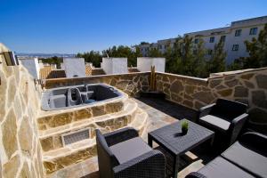 a patio with chairs and a tub on a building at NATURE PLUS Family House in Salou