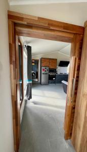 a view of a kitchen with a door open at Rooftop d'exception - calme et confort à Grand Baie in Grand Baie +5 photos