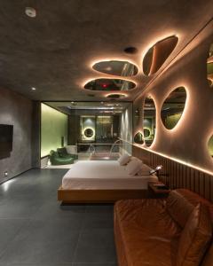 a bedroom with a bed and a couch at Lush Motel Lapa in Sao Paulo +42 photos
