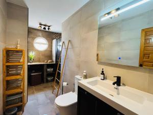 a bathroom with a sink and a toilet and a mirror at Casa Zeus by SunshineClub in Los Alcázares +17 photos