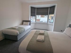 Ένα ή περισσότερα κρεβάτια σε δωμάτιο στο Sundeland Executive Apartments