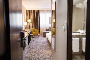 a hotel room with a bed and a bathroom at Grand Hotel Plovdiv in Plovdiv