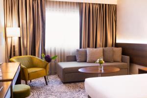 a living room with a couch and a table at Grand Hotel Plovdiv in Plovdiv