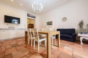 a dining room with a table and a blue couch at Palazzo dello Spagnolo Suite in Naples