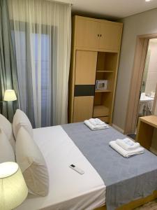 Ένα ή περισσότερα κρεβάτια σε δωμάτιο στο Mirage Taiaa Hotel Apartments