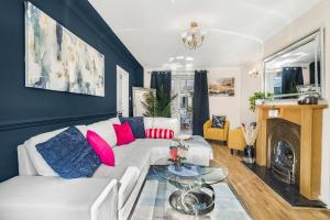 a living room with a white couch and a fireplace at Contractor ready Homes Secure Parking in Middleton