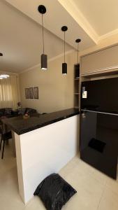 a kitchen with a black and white counter top at Loma Sweet Home in Bataguaçu +7 photos