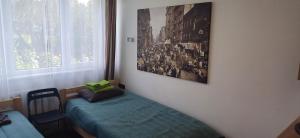 a room with a bed and a picture on the wall at Bridge Apartments Klaipeda in Klaipėda