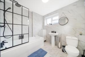 a bathroom with a tub and a toilet and a sink at Charming 3BR Home in Bedford, Sleeps 5 in Bedford