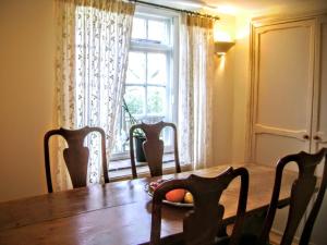 a dining room table with chairs and a window at The Barn - Wheatley - Oxford in Wheatley
