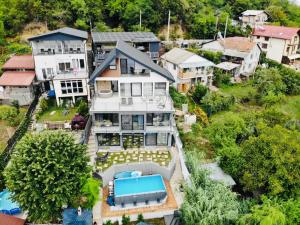 an aerial view of a house with a swimming pool at NOAH river house in Orşova