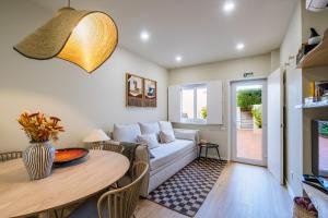 a living room with a couch and a table at 2BR Private Pool House Near Lisbon & Beaches in Parede