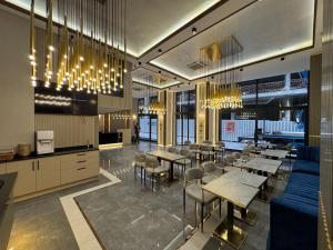 a restaurant with tables and chairs and chandeliers at Elysia Hotel in Istanbul