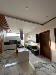 eine große Küche mit Marmorboden und einem Tisch in der Unterkunft 5 bed room luxury villa in DHA phase 8 in Lahore