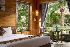 a bedroom with a bed and a large window at Tam Coc Orchid Hotel & Spa in Ninh Binh
