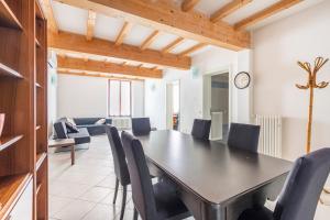 a dining room with a black table and chairs at Large apartment with 2 bedrooms in the historic center in Reggio Emilia