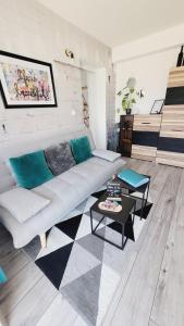 a living room with a couch and a piano at Le ptit Cosy appartement privatif in Bining-lès-Rohrbach +37 photos