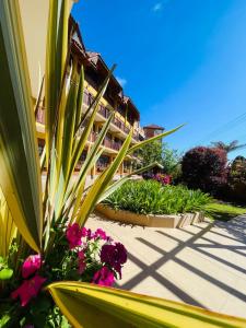 a building with a bunch of flowers in front of it at Hotel Garnier in Campos do Jordão +150 photos